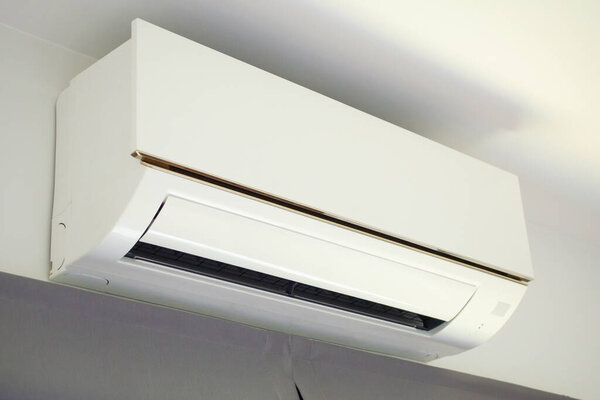 Air conditioner on white wall room interior background