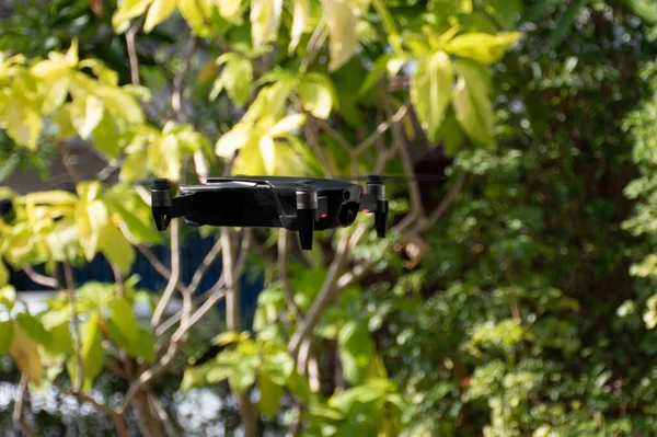 nobody, modern black drone flying in nature with 4 propellers, 4k camera photo, and video. The concept for professionals in the unmanned aircraft technology industry. Close up, crop, Blur background.