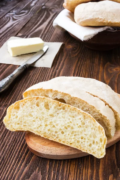 Slice of ciabatta on wooden table — Stock Photo, Image