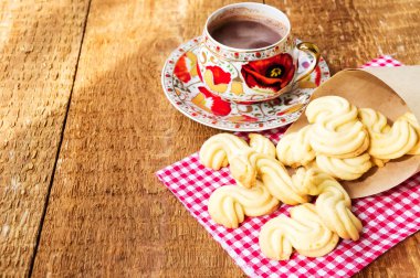Ahşap masa üzerinde sıcak çikolata ile ev yapımı kurabiye