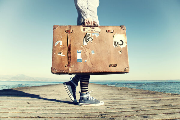 young woman ready to travel with her suitcase