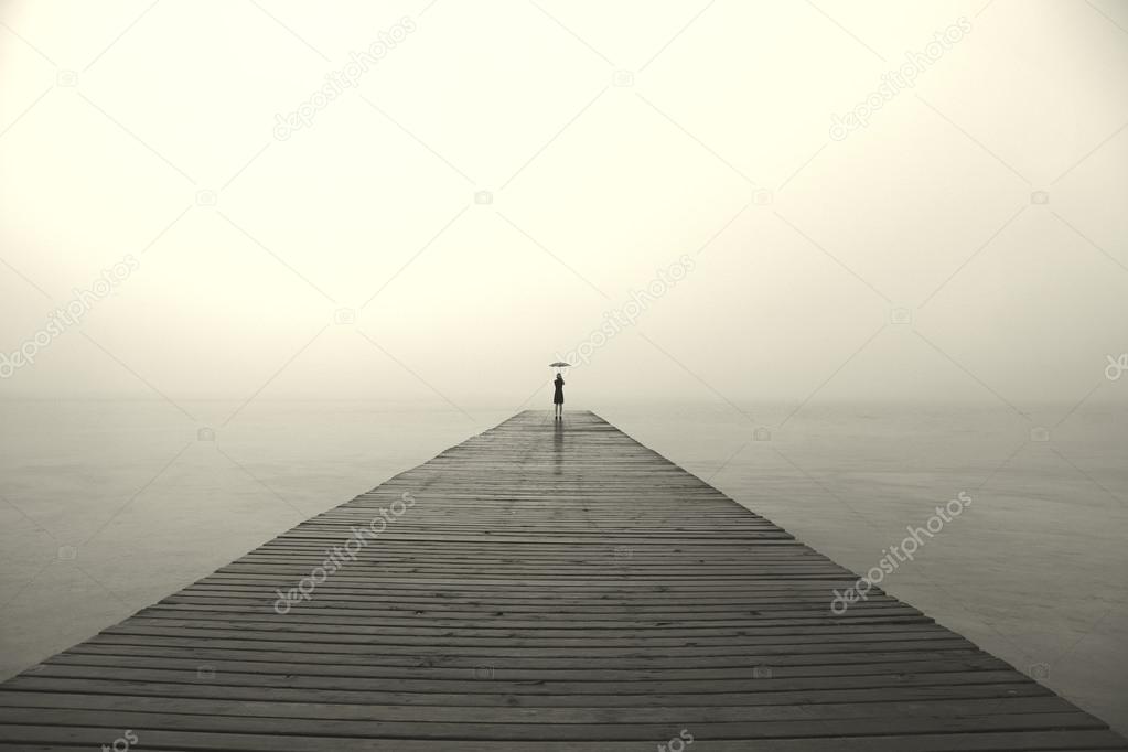 woman with black umbrella looking infinity in a surreal place