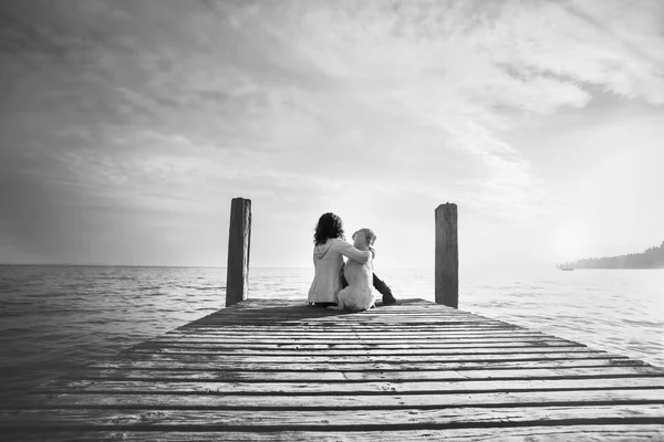 Woman embracing sweetly his dog while looking the view — Stock Photo, Image