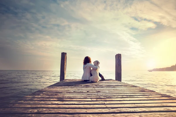 Woman embracing sweetly his dog while looking the view — Stock Photo, Image