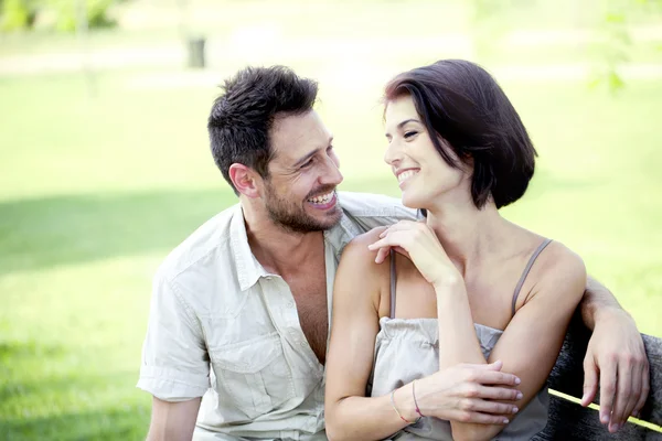 Couple in love seated together on a bench — Stock Photo, Image