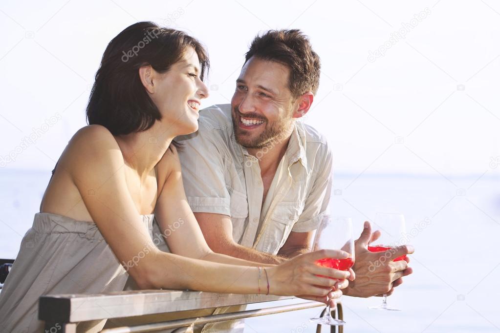 Couple having a spritz time with a lake view