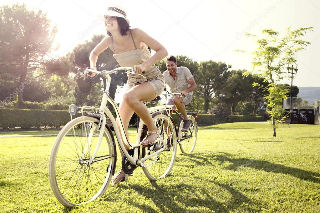 Couple having fun by bike on holiday to the lake in Italy