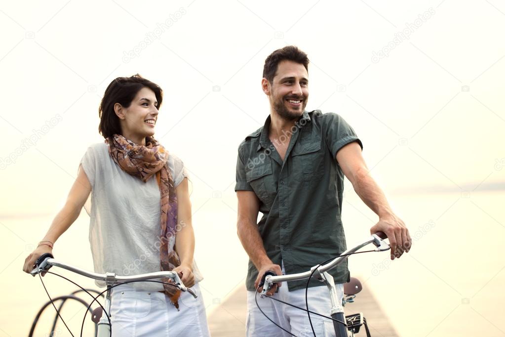 Couple in love pushing bicycle together