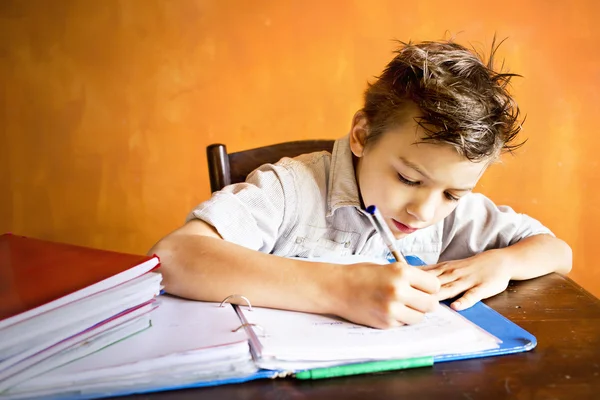 A young boy is doing homework Royalty Free Stock Photos