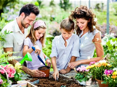 Family have fun in the work  of gardening