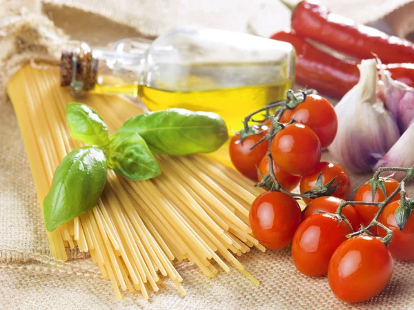 Composition of pasta spaghetti vegetables, spices and oil — Stock Photo, Image