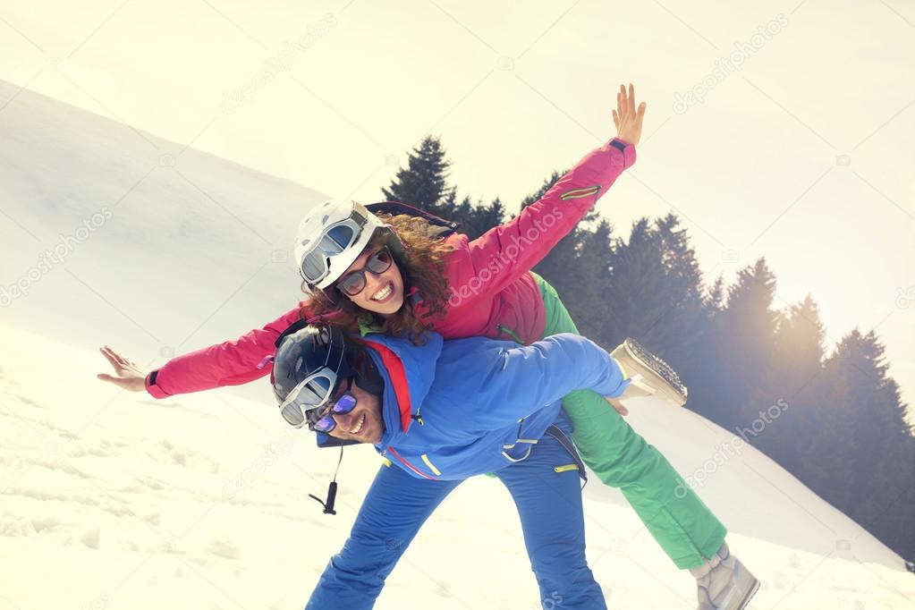 Couple in love having fun in mountain at sunset