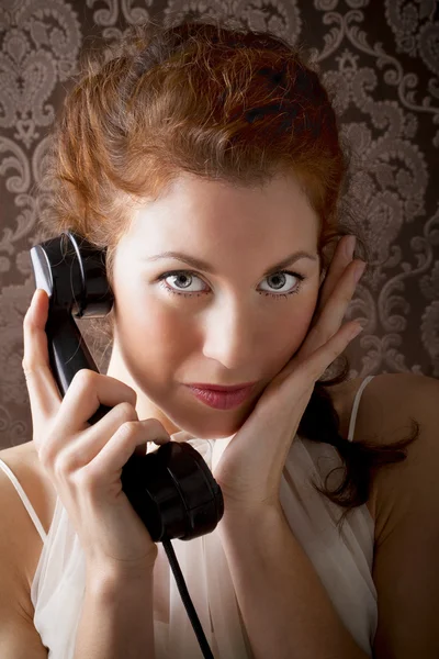 Beautiful woman is phoning with a vintage phone — Stock Photo, Image