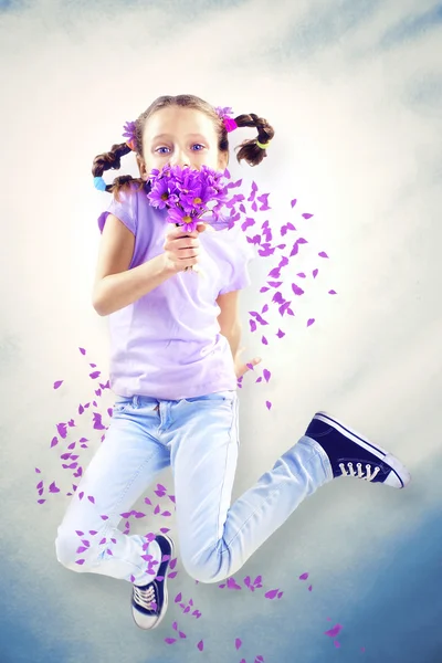 Little girl smelling flower in spring — Stock Photo, Image