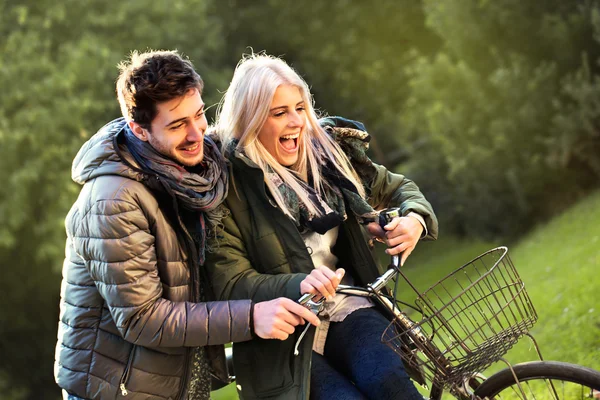 Couple having a bicycles race into the nature — Stock Photo, Image