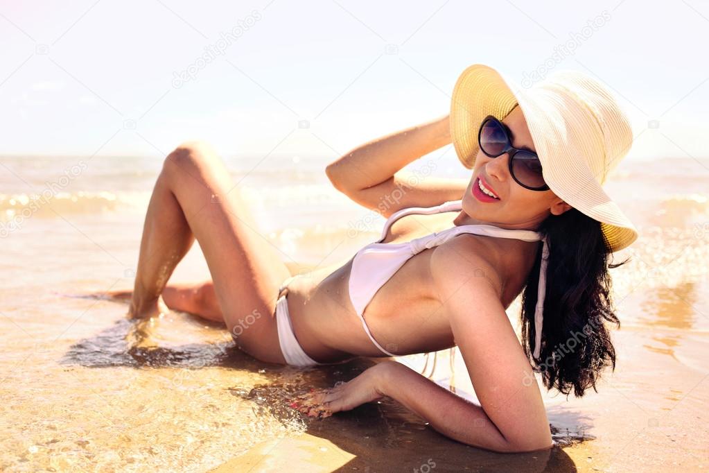 Beautiful girl sunbathing lying in the sea