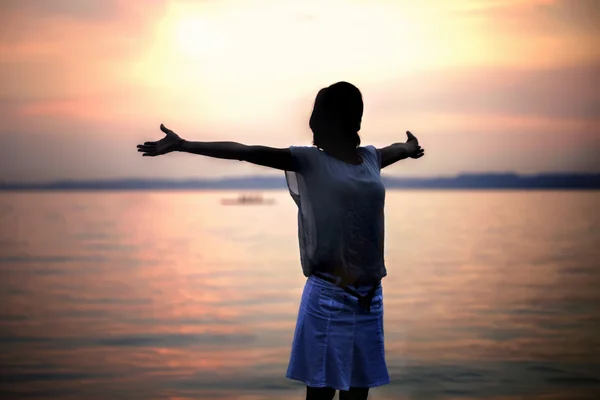 背光女人深吸一口气在夕阳的余晖 — 图库照片