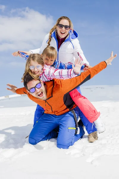 Young family having fun in the snow Royalty Free Stock Photos