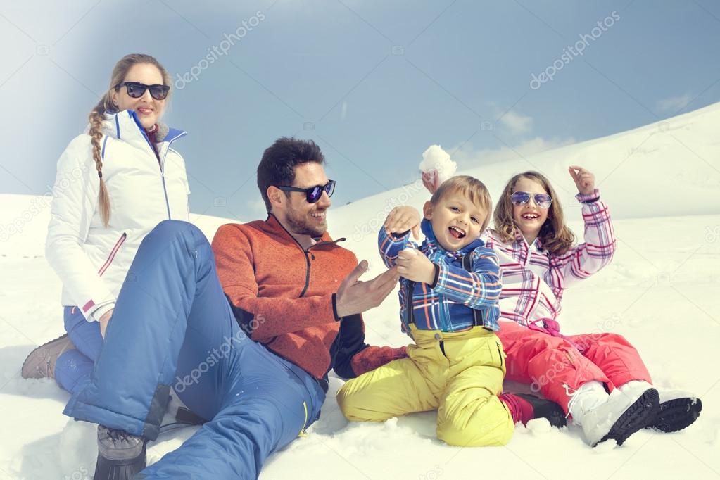 family having fun in the snow