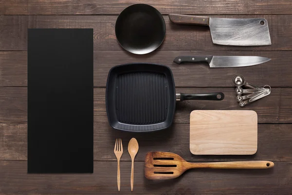 Various kitchenware utensils on the wooden background — Stock Photo, Image