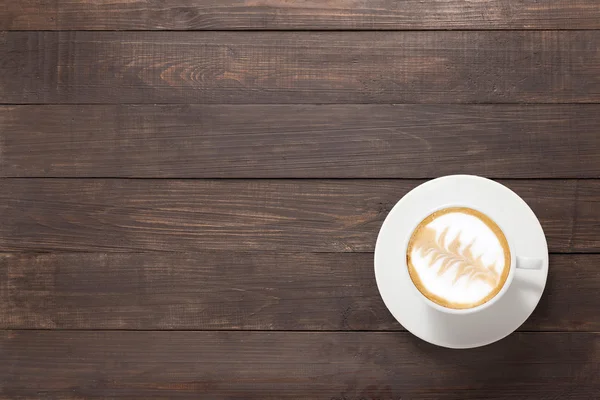 Taza de café sobre fondo de madera. Vista superior — Foto de Stock