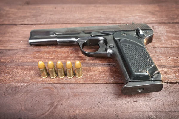 Semi-automatic 9mm gun isolated on wooden background — Stock Photo, Image