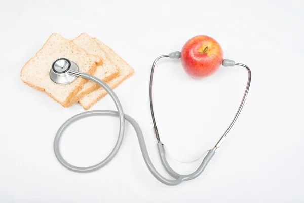 Stethoscope with red apple isolated on white — Stock Photo, Image