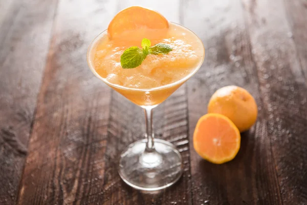 Orange juice in glass, fresh fruits on wooden background — Stock Photo, Image