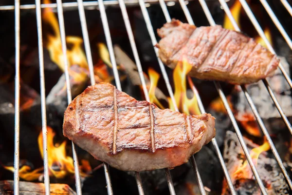 Főzés során a lángoló grill sertés szelet. — Stock Fotó