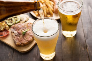 Bira cam gurme biftek ve patates kızartması ile içine dökülür varlık