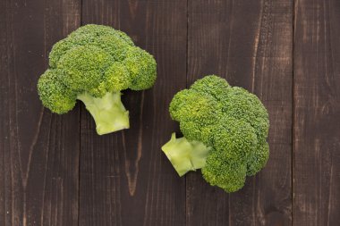 Fresh green broccoli on the wooden background clipart