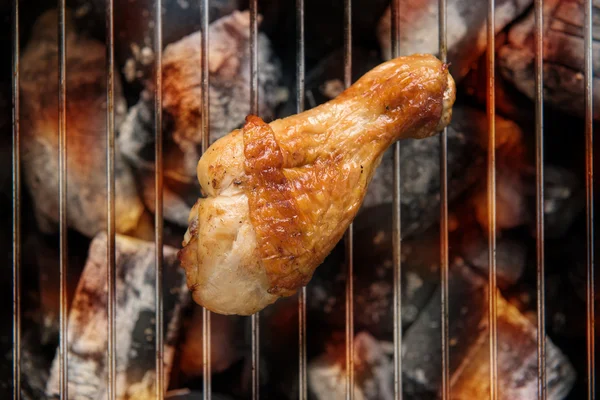 Chicken legs grilling over flames on a barbecue. — Stock Photo, Image