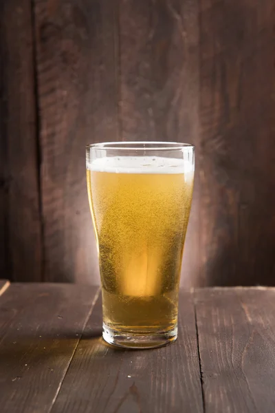 Glass of light beer on wooden background. — Stock Photo, Image