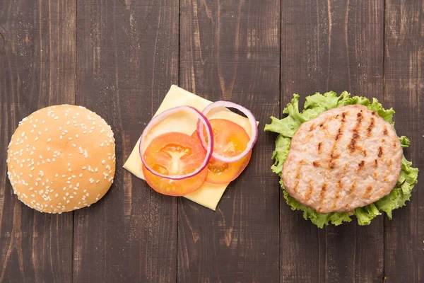 Top view bbq Hamburger parts horizontal on the wooden background — Stock Photo, Image