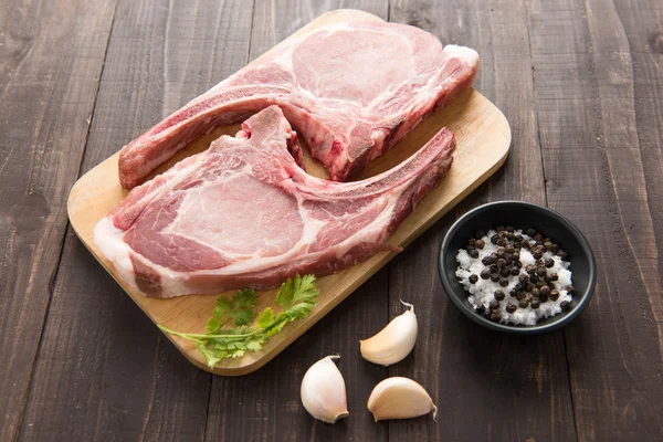 Fresh Raw Pork Chops on wooden background. — Stock Photo, Image