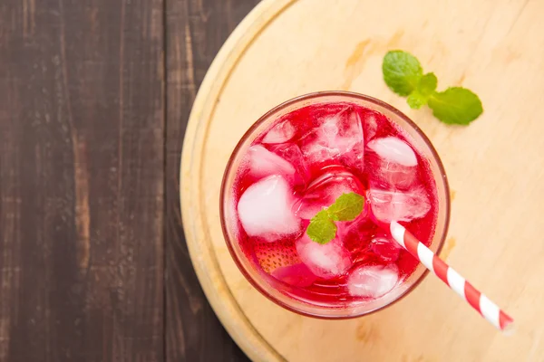 Red Cocktail with mint and ice on wooden table — Stock Photo, Image