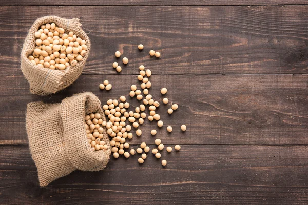 Top view soybean on wooden background and empty space — Stock Photo, Image