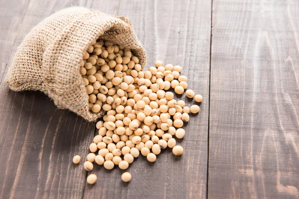 Top view soybean on wooden background and empty space. — Stock Photo, Image