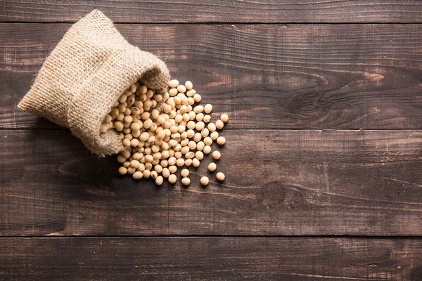 Top view soybean on wooden background and empty space — Stock Photo, Image