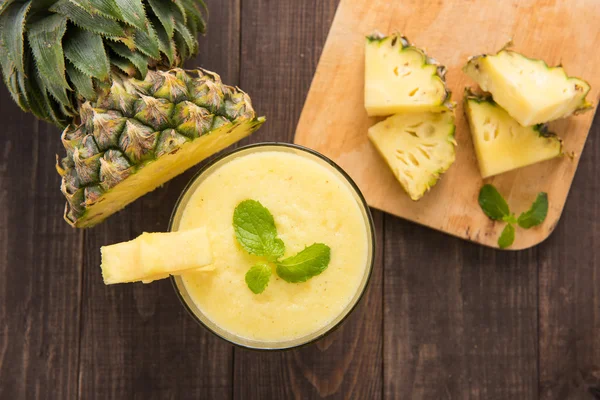 Ananassmoothie med fersk ananas på trebord – stockfoto