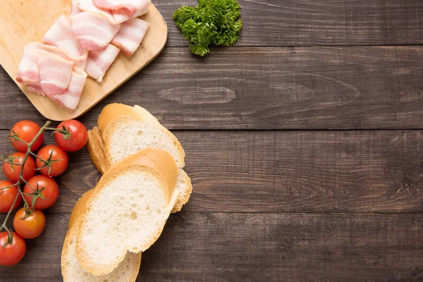Ingredients for sandwich on wooden background