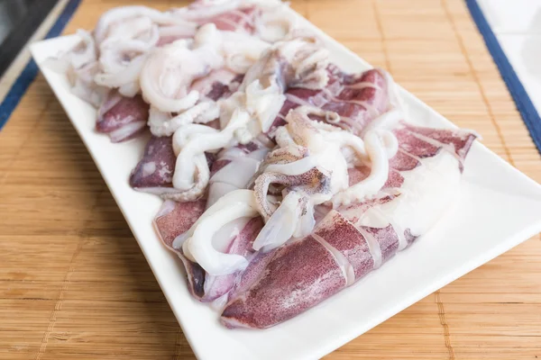 Fresh squid on a dish on the table — Stock Photo, Image