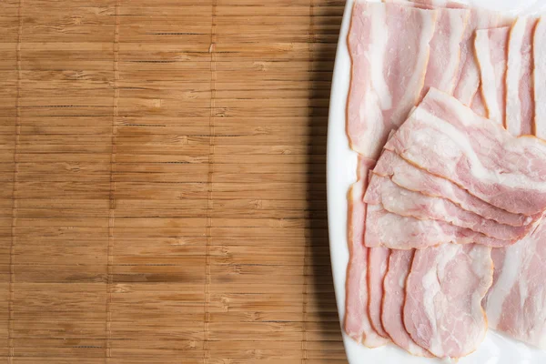 Slided bacon on white dish for gourmet — Stock Photo, Image