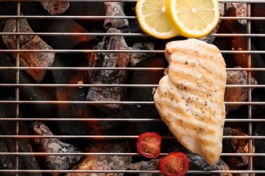 Grilled chicken breast on the flaming grill clipart