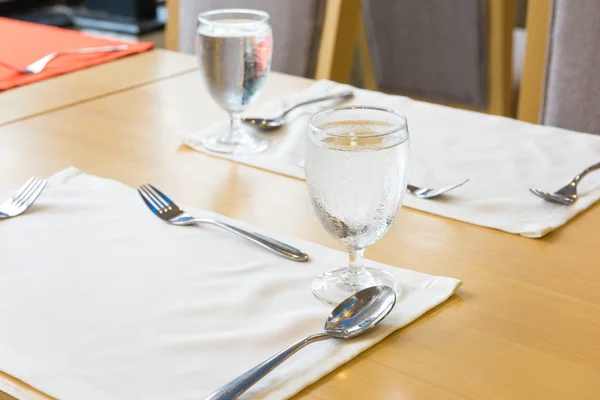 Glass of water on table setting for dining — Stock Photo, Image