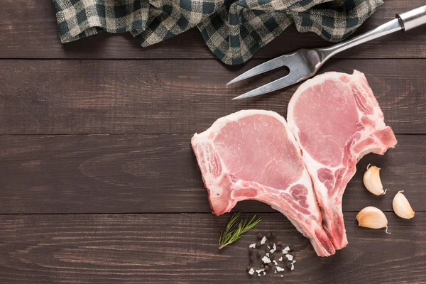 Top view raw fresh meat and salt, pepper, garlic, meat fork on w — Stock Photo, Image