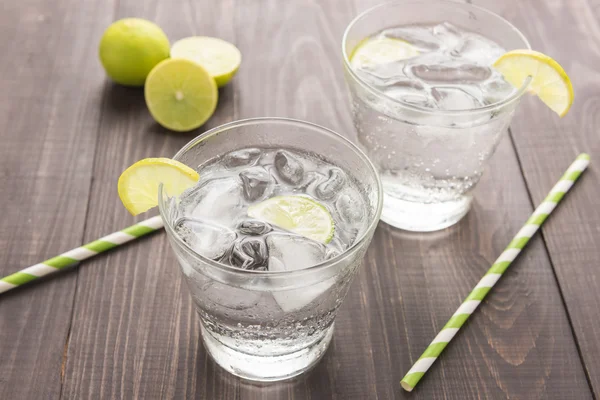 Fresh cocktail with soda, lime on a wooden background — Stock Photo, Image