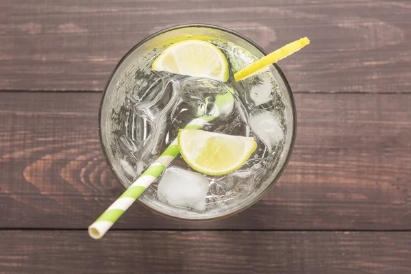 Fresh cocktail with soda, lime on a wooden background — Stock Photo, Image