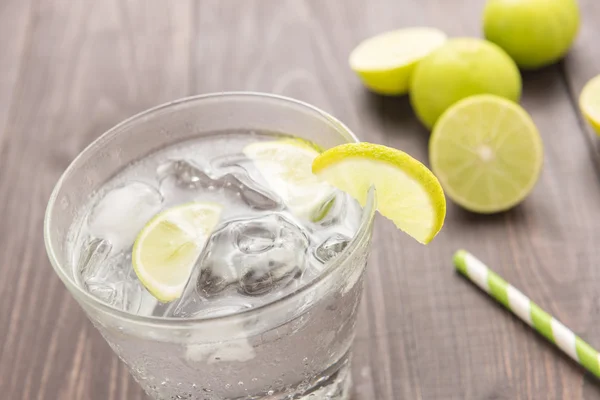 Fresh cocktail with soda, lime on a wooden background — Stock Photo, Image