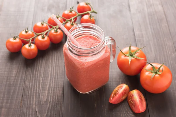 Healthy vegetable. Glass of red tomato juice on wooden table — Stock Photo, Image